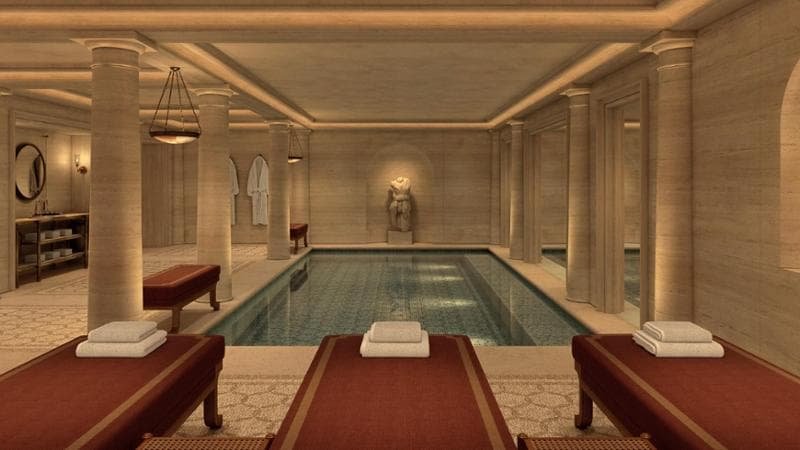 Rendering di una piscina interna con lettini nel progetto alberghiero romano